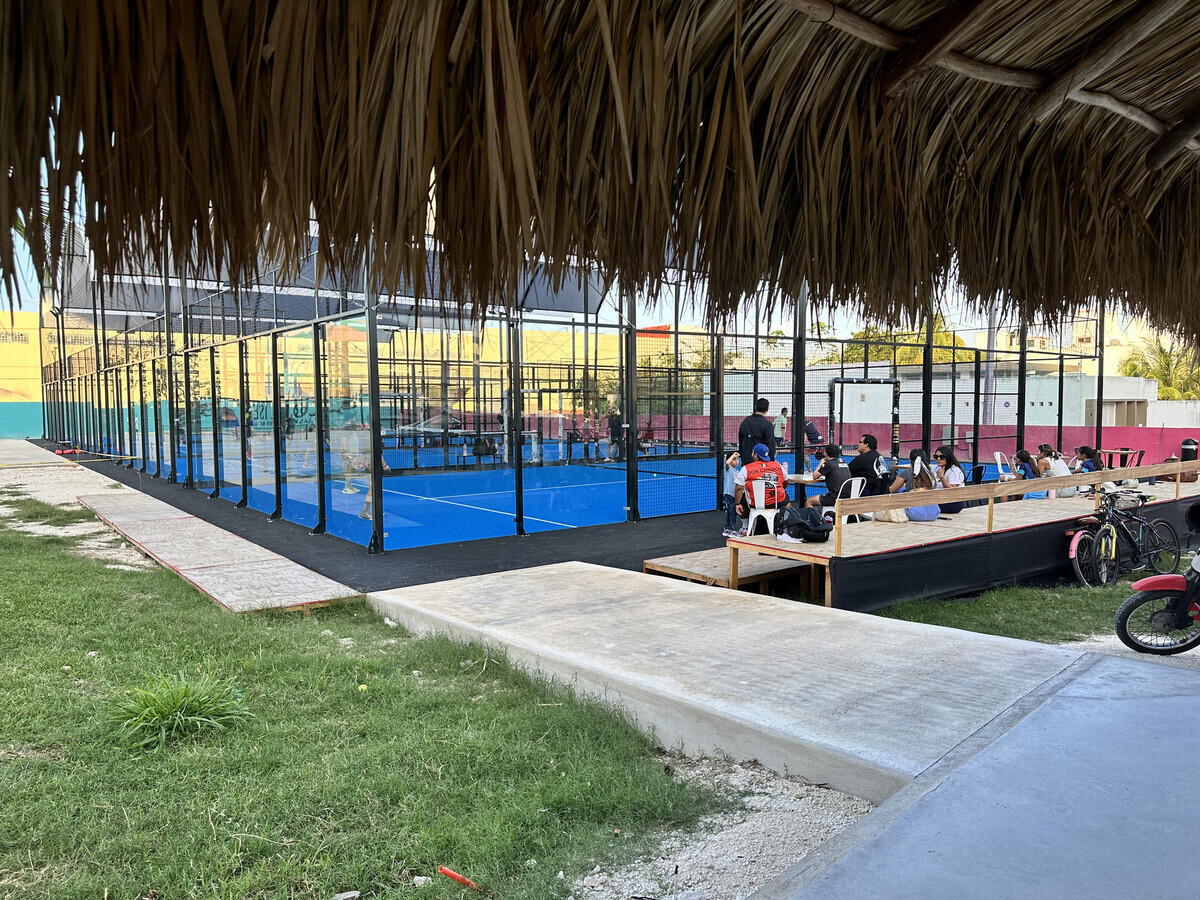 Players enjoying a doubles match on an oceanfront pickleball court